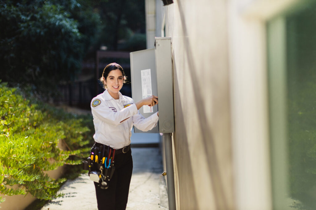 Female Tech Working on Electrical Panel